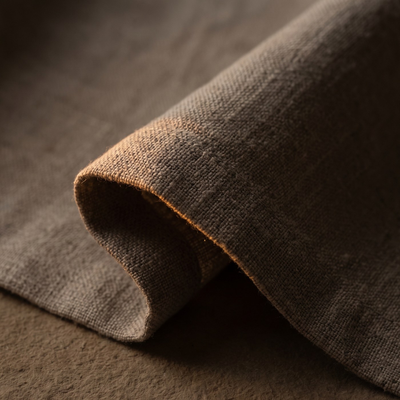 Close detail of heavy natural linen folded across the bench cushion.